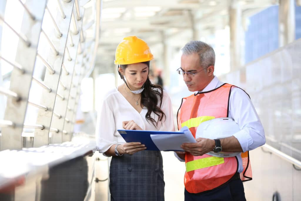 civil-engineers-looking-on-blueprints-at-construction-site