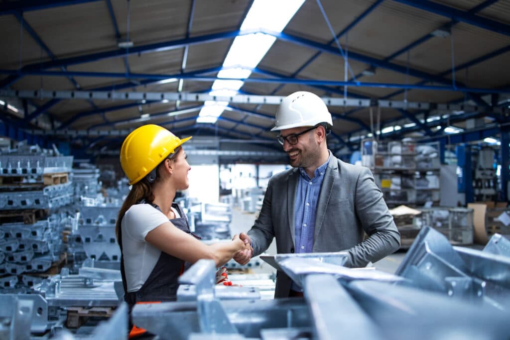 factory-manager-visiting-production-line-and-congratulating-worker-on-promotion-for-hard-work-and-good-results