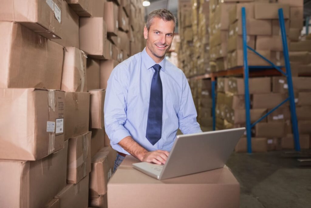 portrait-of-warehouse-manager-using-laptop